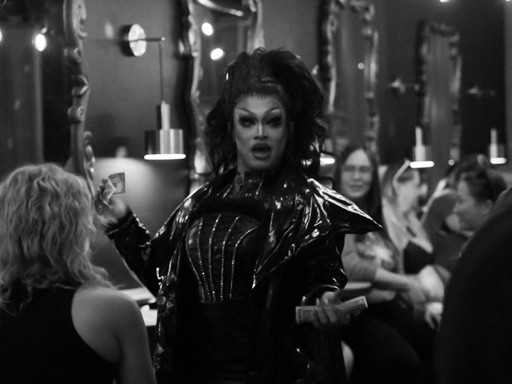 Performer in sequined gown interacting with the front row